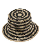 Woven hat with black and beige pattern on a white background
