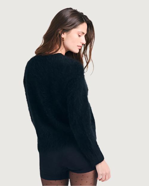 Back View of a person standing against a neutral background, wearing a black, fuzzy-textured sweater with long sleeves and a crew neck.