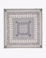 Square pattern scarf featuring concentric rows of skulls in alternating white and gray colors, creating a layered and symmetrical design