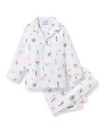  Children's white pajama set with a long-sleeved, collared button-up shirt featuring a chest pocket, and matching pants with an elastic waistband. The fabric is decorated with colorful, playful illustrations of various characters and animals.