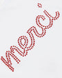 Decorative red rhinestone with the text merci design on a white background