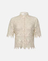 A beige short-sleeved, lace blouse with a floral pattern. The blouse features a collar and a front button closure, and scalloped edges on the sleeve and hem.
