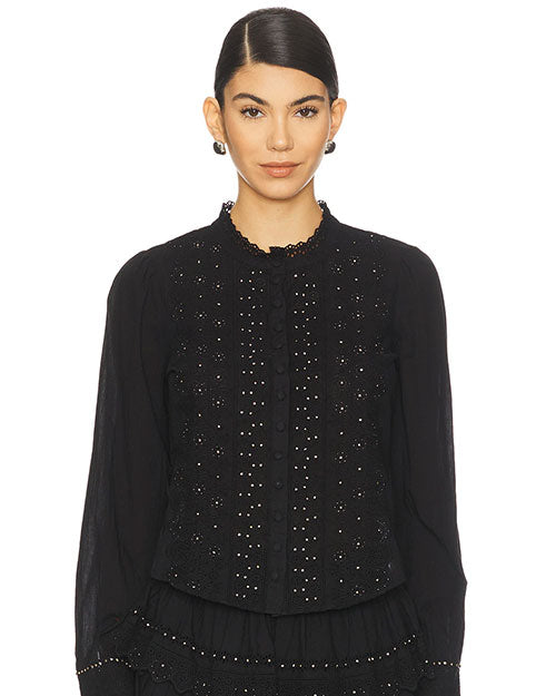 Front view of a black long-sleeve blouse featuring a scalloped neckline, button-down front, intricate eyelet embroidery with small stud embellishments, and a slightly flared hem.