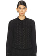 Front view of a black long-sleeve blouse featuring a scalloped neckline, button-down front, intricate eyelet embroidery with small stud embellishments, and a slightly flared hem.