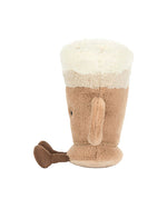 Plush toy resembling a latte with a light brown body, white fluffy foam top, side handle, and a small brown heart attached to the handle.