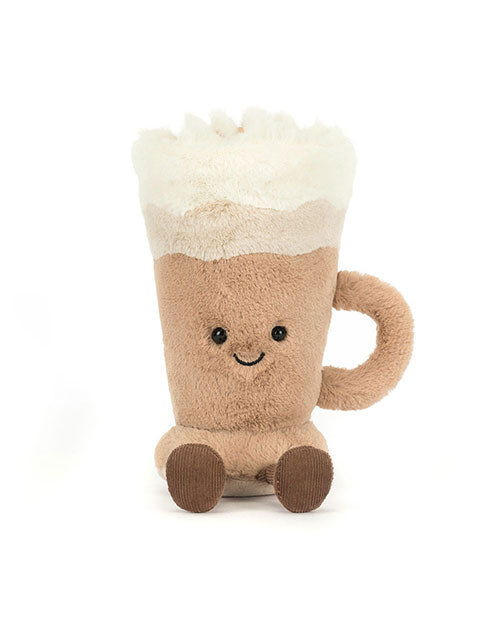Plush toy shaped like a mug filled with a frothy beverage, featuring a light brown body, white foam top, black button eyes, smiling mouth, small legs, and a side handle.