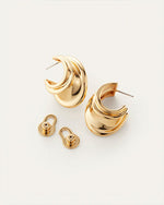 Pair of gold hoop earrings with a unique, layered design and shiny polished finish; includes two matching gold earring backs and visible posts for pierced ears.