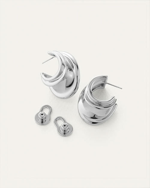Pair of silver hoop earrings with a unique, layered design; includes two silver earring backs with circular bases and oval loops.
