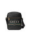 Black textured leather Gucci crossbody bag with gold hardware, featuring the iconic green and red stripe and double G logo. Adjustable strap for crossbody wear.