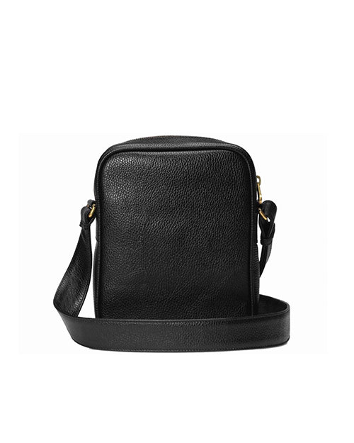 The back view of a black leather crossbody bag with a pebbled texture. The bag has a rounded rectangular shape and features a gold-toned zipper closure at the top. It includes an adjustable strap attached with gold-toned clasps and hardware.