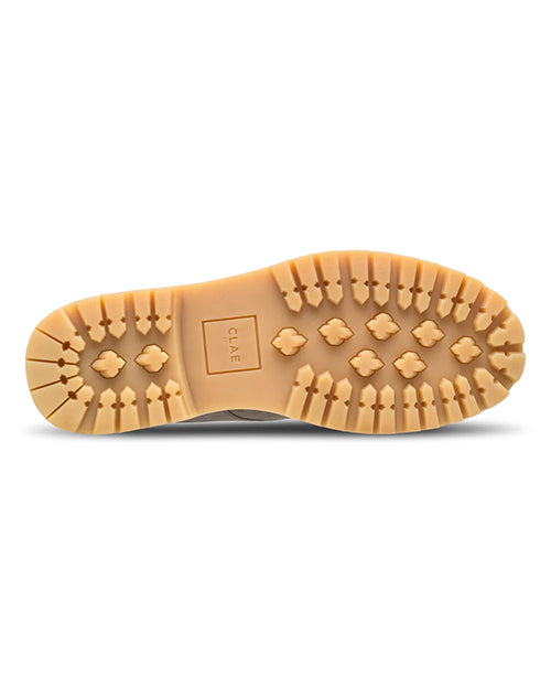 Close-up of a tan sole with brand logo on a white background