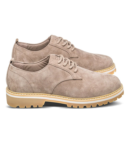 Side view of a pair of beige suede shoes with white soles on a white background