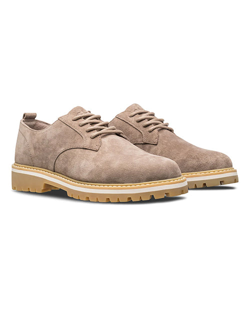 Pair of brown suede shoes with white and brown soles on a white background