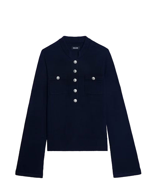  Long-sleeved, dark-colored shirt with a high collar, featuring six metallic buttons down the front and two chest pockets each with two buttons. A small label is visible near the collar.