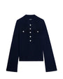  Long-sleeved, dark-colored shirt with a high collar, featuring six metallic buttons down the front and two chest pockets each with two buttons. A small label is visible near the collar.