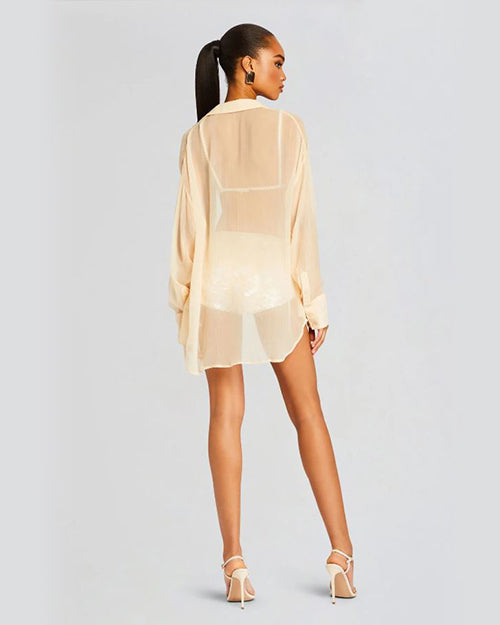Back view of sheer nude top on model with matching high heels.