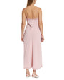 Back view of a pink slip dress worn by a model on a white background