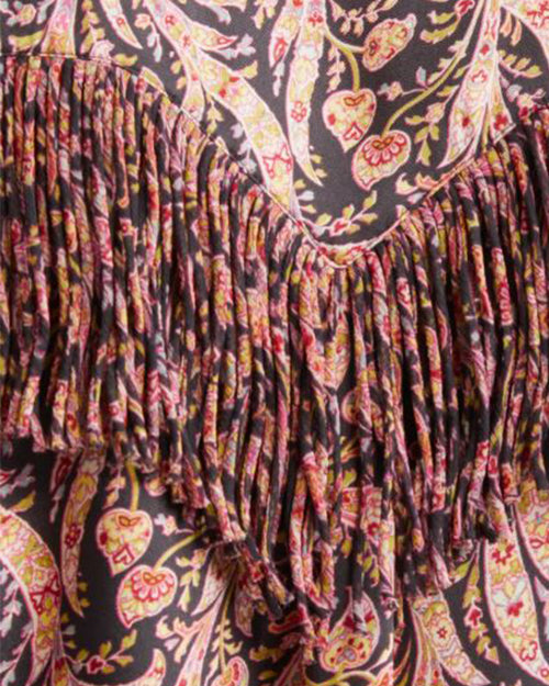 Close-up of a paisley pattern in pink, yellow, and black, featuring fringe detailing
