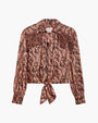 Women's long-sleeve paisley blouse in pink, orange, and black with a collared neckline, button-down front, tie-front hem, and frindge details on white background