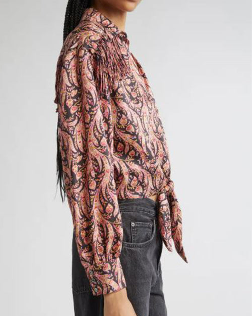 Side view of a person wearing a patterned long sleeve shirt with dakr jeans