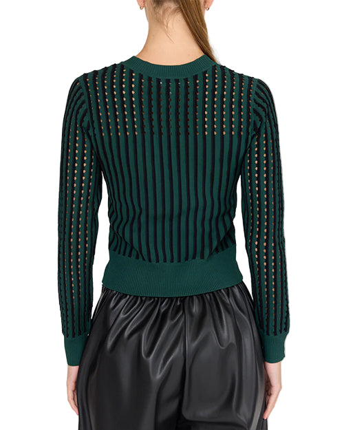 back view of a  person wearing a green and black vertically striped sweater with long sleeves