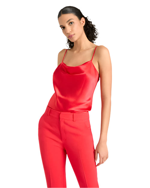 Front view of a woman wearing a red silk top and pants on a light background