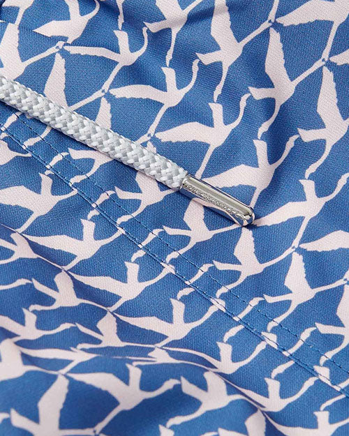 Close up of a blue with light nude flamingo pattern throughout.