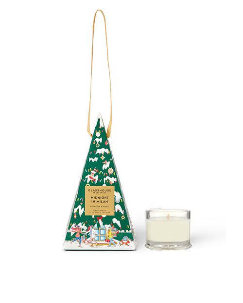 Decorative candle in a green tree-shaped packaging with a white background