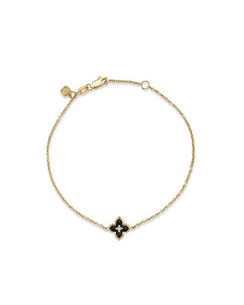 A gold bracelet with a delicate chain design featuring a Black Moroccan Flower with a pave diamond on the center.