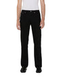 Front view of a person standing upright, wearing black pants, black shoes, and a white shirt.