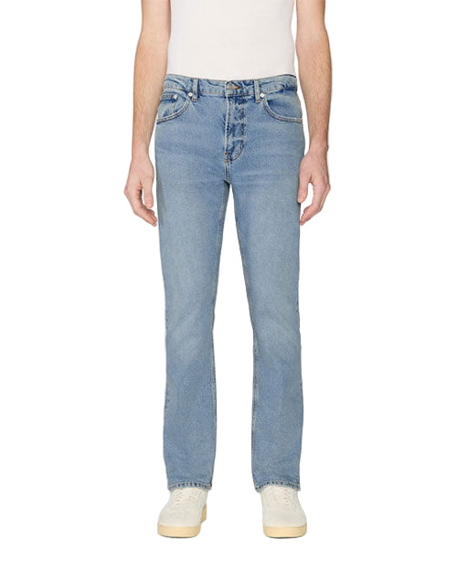 Front view of a person wearing light blue jeans and white shoes, with a partially visible white shirt. The jeans are shown in full length.