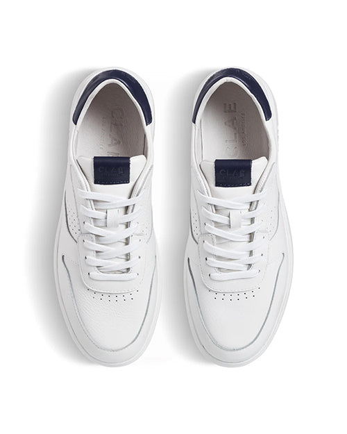 Top view of a pair of white sneakers with navy accents on a white background