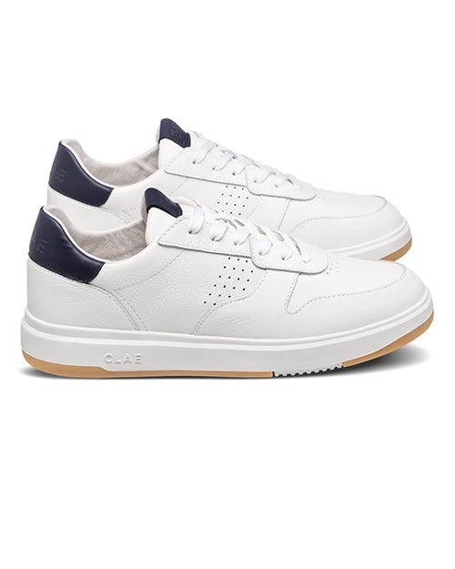 White sneakers with navy accents on a white background