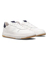 White sneakers with navy accents on a white background