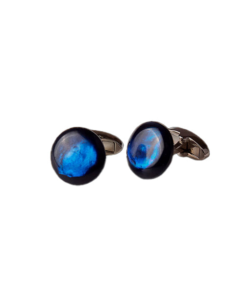 Cufflinks with mother of pearl blue circular design on a white background
