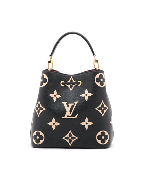 A back view of a black designer handbag with a distinctive pattern of beige-colored symbols and monograms, including stylized flowers and the letters ‘LV’ for Louis Vuitton. The bag has a curved top edge, two gold-tone metal rings attaching the handle to the body.