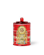 Red decorativeglass candle with intricate design on a white background