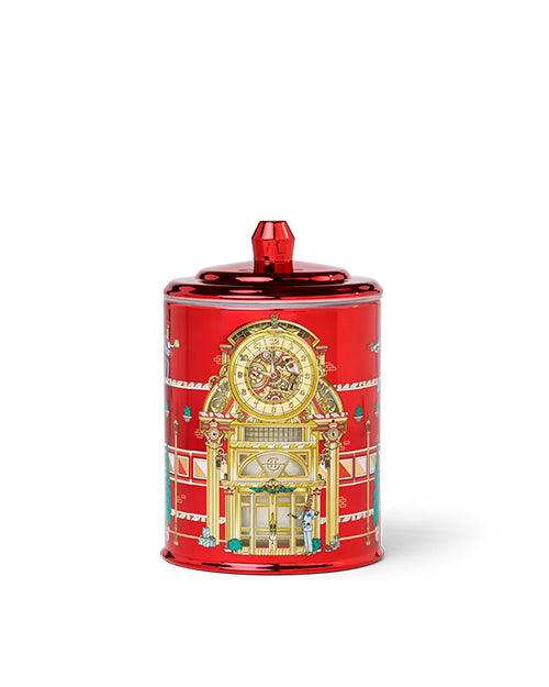 Red decorativeglass candle with intricate design on a white background