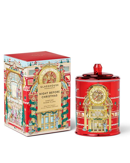 Red holiday candle in a glass container with lid, paired with a matching decorative box, set against a white background.