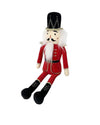 A traditional nutcracker doll with a black hat, white hair, mustache, and beard. It wears a red and gold uniform and black boots, sitting upright.