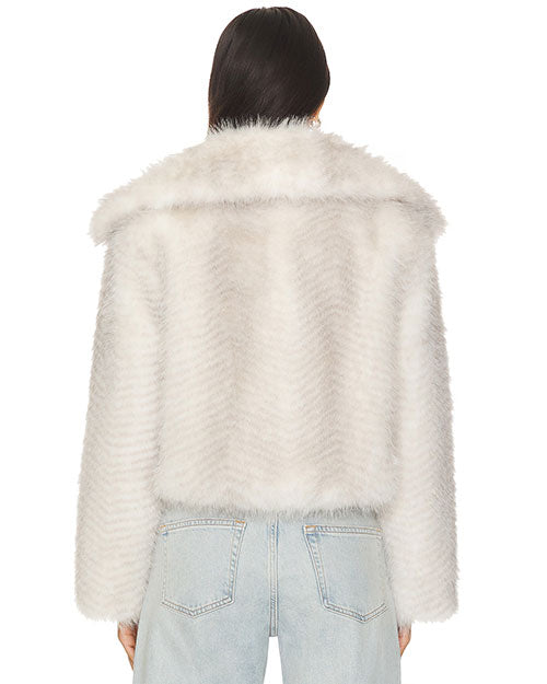 Back view of a light gray faux fur jacket featuring a wide collar and a soft, plush texture, paired with light wash denim jeans.