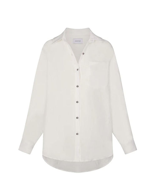 Linen oversized dress shirt in white on a white background.