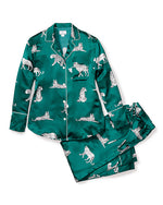 An emerald green silk pajama set consisting of a long-sleeved button-up shirt and matching pants, both adorned with a white leopard print pattern. The pajamas are laid flat on a plain surface.