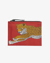 A rectangular pouch with a vibrant red background. It features a detailed illustration of a Mykonos leopard. The zipper of the pouch is at the top and black. 