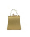 A back view of small handbag featuring a pearl handle. The bag is primarily gold in color with with white stitching along the sides.