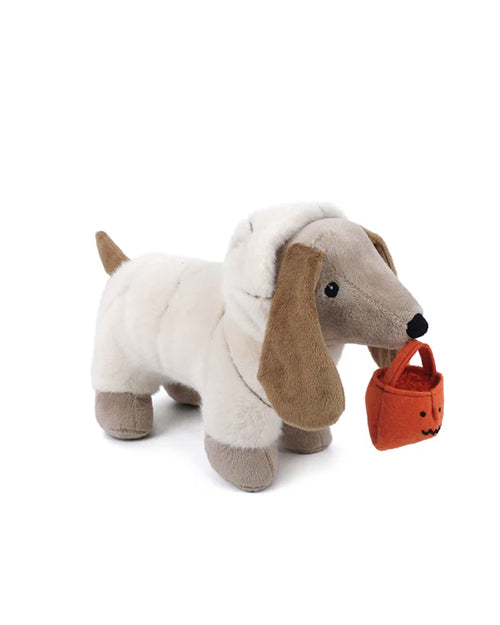 Plush dachshund toy holding a small orange bucket on a white background