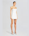 A model wearing a strapless white mini dress with a straight neckline and a fitted silhouette. The dress features lace trim at the bust and hemline. The model is styled with white high heels.