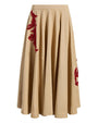 Beige skirt with red floral embroidery on a white background