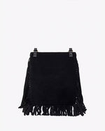 A full backside view of a black handbag with tassels at the bottom, sitting in front of a white background.