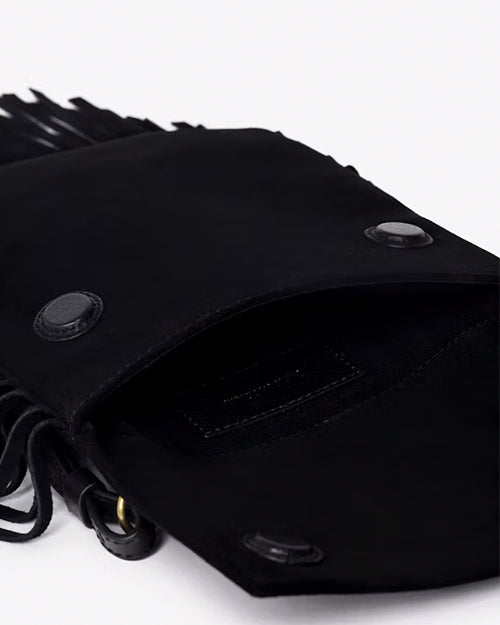 A close-up view of a black with an open flap featuring two snap buttons for closure. The interior of the bag is visible, showing an inner pocket, and fringes are visible along the sides and at the bottom. The background is plain white.